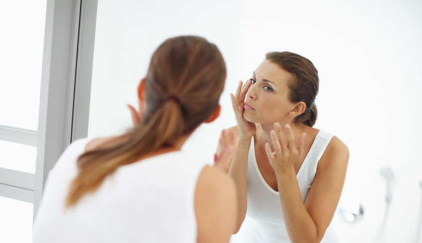 woman looking in the mirror